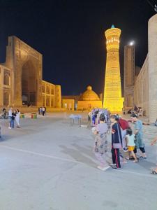 a group of people standing in front of a building at Asal boutique hotel in Bukhara