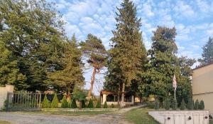 a garden with trees and a fence and a house at Hotel Giorgi in Tskaltubo