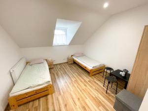 a small room with two beds and a table at Frankowo in Teodorówka