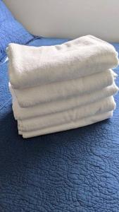 a stack of towels sitting on top of a bed at Lovely 1-Bedroom Condo with Pool, walking distance to the beach in Sosúa