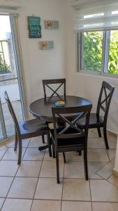 a dining room with a black table and chairs at Lovely 1-Bedroom Condo with Pool, walking distance to the beach in Sosúa