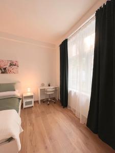 een slaapkamer met een bed, een raam en een bureau bij Verde in Zagreb