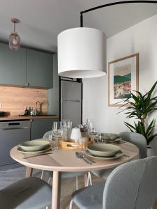 a dining room table with chairs and a white pendant light at Le Cœur d’Agen in Agen +9 photos