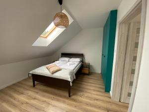 a bedroom with a bed and a green door at Apartament Chleb i Wino in Krynica Zdrój