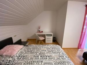 a bedroom with a bed and a desk in a room at Ferienwohnung Bad Säckingen ruhig und zentral in Bad Säckingen