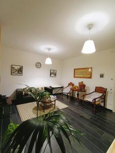 ein Wohnzimmer mit einem Sofa, Stühlen und einem Tisch in der Unterkunft Affittacamere Casa Marconi in Comacchio