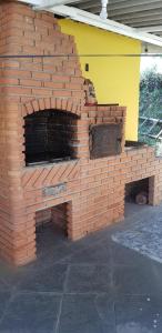 an outdoor brick oven with a yellow top at Bela Chácara in Suzano