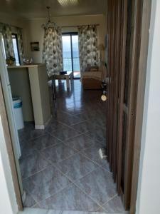 a view of a living room with a tile floor at Bousounis Apartments in Chrani
