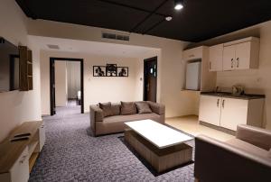 a living room with a couch and a table at Diamond Hotel in Amman