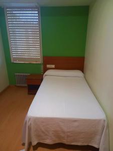 Postel nebo postele na pokoji v ubytování Pension San Roque