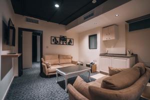 a living room with two couches and a table at Diamond Hotel in Amman