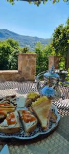 a plate of bread and a tea kettle on a table at La Corte dei Cerri, Il Tornio in Spervara