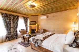 A bed or beds in a room at Atilla's Cave Hotel