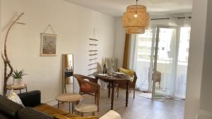 a living room with a table and chairs at Large apartment near the beaches of Mourillon in Toulon