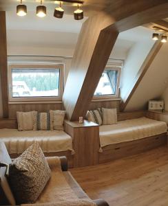 a room with two beds and a couch at NevSki Apartments in Kopaonik