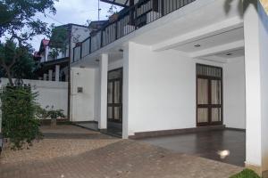 a white building with doors and a courtyard at Arazia in Panadura