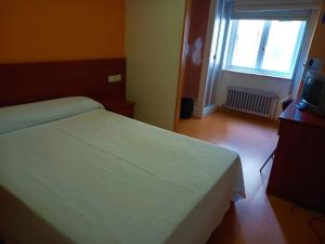 Postel nebo postele na pokoji v ubytování Pension San Roque