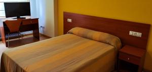 Postel nebo postele na pokoji v ubytování Pension San Roque