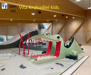 een kinderspeelplaats met een dinosaurusglijbaan bij Hotel Acropolis " Op het sportiefste park van de kust " in Middelkerke