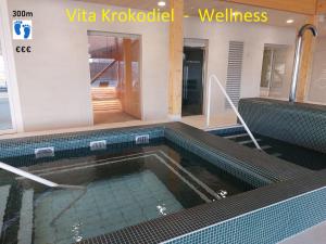 a swimming pool in a building with a swimming pool at Hotel Acropolis " Op het sportiefste park van de kust " in Middelkerke