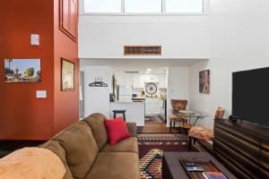 a living room with a couch and a kitchen at Nightlife & Shop Old Town Scottsdale - Studio Unit in Scottsdale
