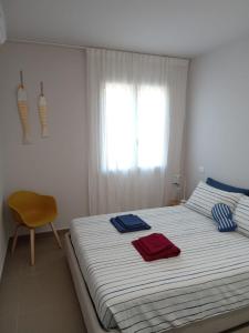 a bedroom with a bed with two towels on it at SeSil Amare in Porto Recanati