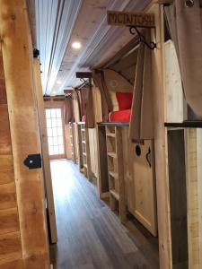 a row of bunk beds in a tiny house at THE ORCHARD (HOSTEL WITH PRIVATE BUNKS) in Radium Hot Springs