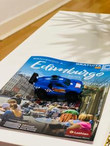 a magazine with a blue toy car on the cover at MODERN 2bed 2bath Ground Floor Apartment in Edinburgh