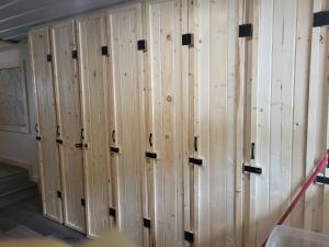 a row of wooden lockers in a room at THE ORCHARD (HOSTEL WITH PRIVATE BUNKS) in Radium Hot Springs