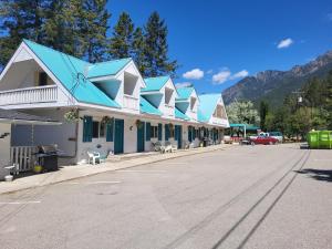 a building with a blue roof on a street at THE ORCHARD (HOSTEL WITH PRIVATE BUNKS) in Radium Hot Springs