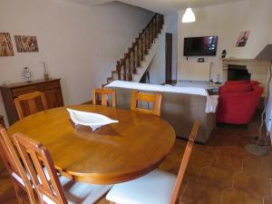 a dining room with a table and a couch at Casas da praia Supertubos in Peniche +25 photos