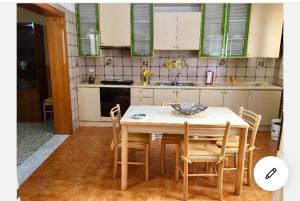 a kitchen with a table and chairs in a kitchen at Casa Tanina in Scordia
