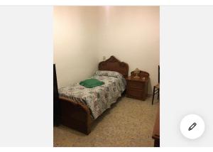 a small bedroom with a bed and a night stand at Casa Tanina in Scordia +9 photos