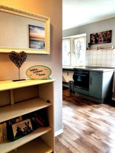 a kitchen with a stove and a counter top at Rostock hautnah erleben - schöne Maisonette 2OG in Rostock