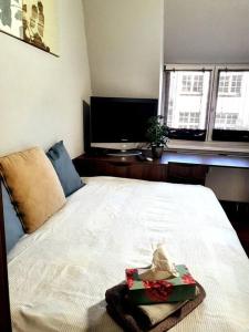 a bedroom with a bed with a christmas present on it at Rostock hautnah erleben - schöne Maisonette 2OG in Rostock