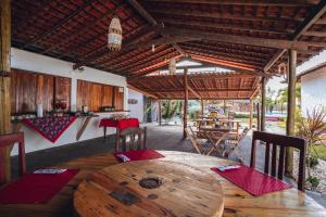 a dining room with a wooden table and chairs at Pousada Juventus in Barra Grande