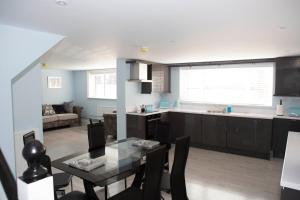 a kitchen and dining room with a table and a kitchen and a living room at 2 Slieve Gullion View Newry in Newry +9 photos