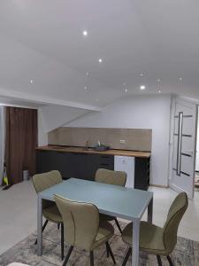 a kitchen with a table and chairs in a room at Anton Lux Apartment in Kočani