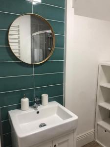 a bathroom with a white sink and a mirror at Lovely Seafront 2 bed flat in Aberystwyth in Aberystwyth