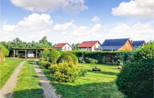 a garden with bushes and houses in the background at Cozy Apartment In Kopalino With Kitchenette in Kopalino