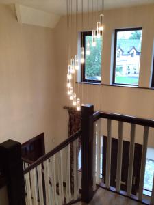a staircase in a house with a chandelier at Errew Lodge in Mohill