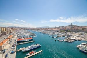 boats are docked in a harbor at Europe Hotel Vieux Port in Marseille