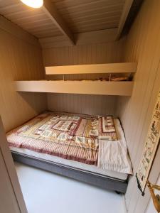 a small room with a bed in a cabin at Cozy Cottage in Icelandic nature with Hot tub in Akranes