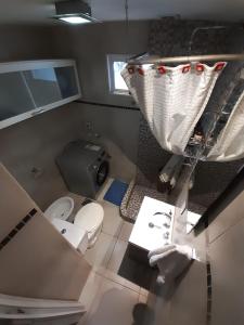 a small bathroom with a toilet and a sink at Estación Libertad in Perito Moreno