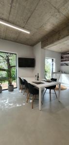 a dining room with a white table and chairs at HOUSE G in Dekani