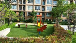 a playground in a park in front of a building at The Relaxing Room Mountain View at Baan Tew Lom Condominium Cha Am - Hua Hin in Cha Am
