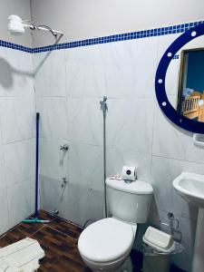 a bathroom with a toilet and a sink at SV Apart Hotel in Encarnación