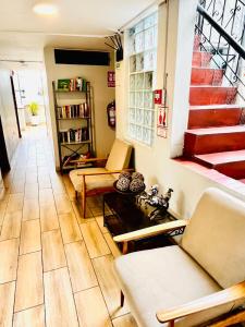 a living room with chairs and a staircase at Imperial Inn Hospedaje Turistico in Lima