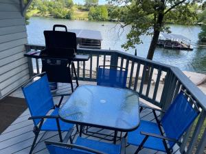 a patio with chairs and a grill and a table at Lakeshore Fishing Cabin #2 in Lake Ozark