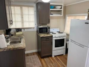 a kitchen with a white stove and a refrigerator at Lakeshore Fishing Cabin #2 in Lake Ozark